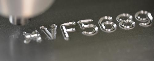 VIN marking on a metal surface, showing engraved alphanumeric vehicle code